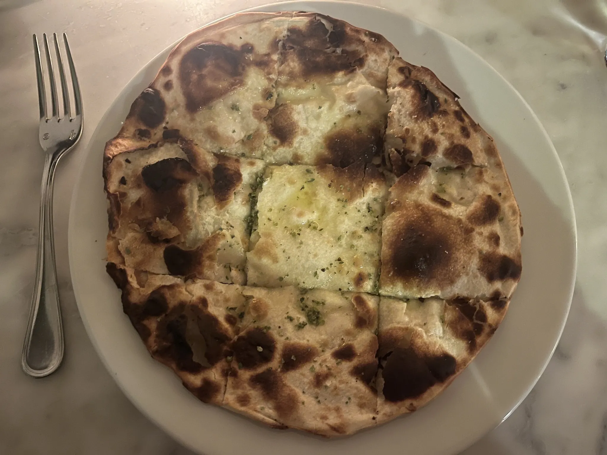 Borgo's focaccia bread on a marble table