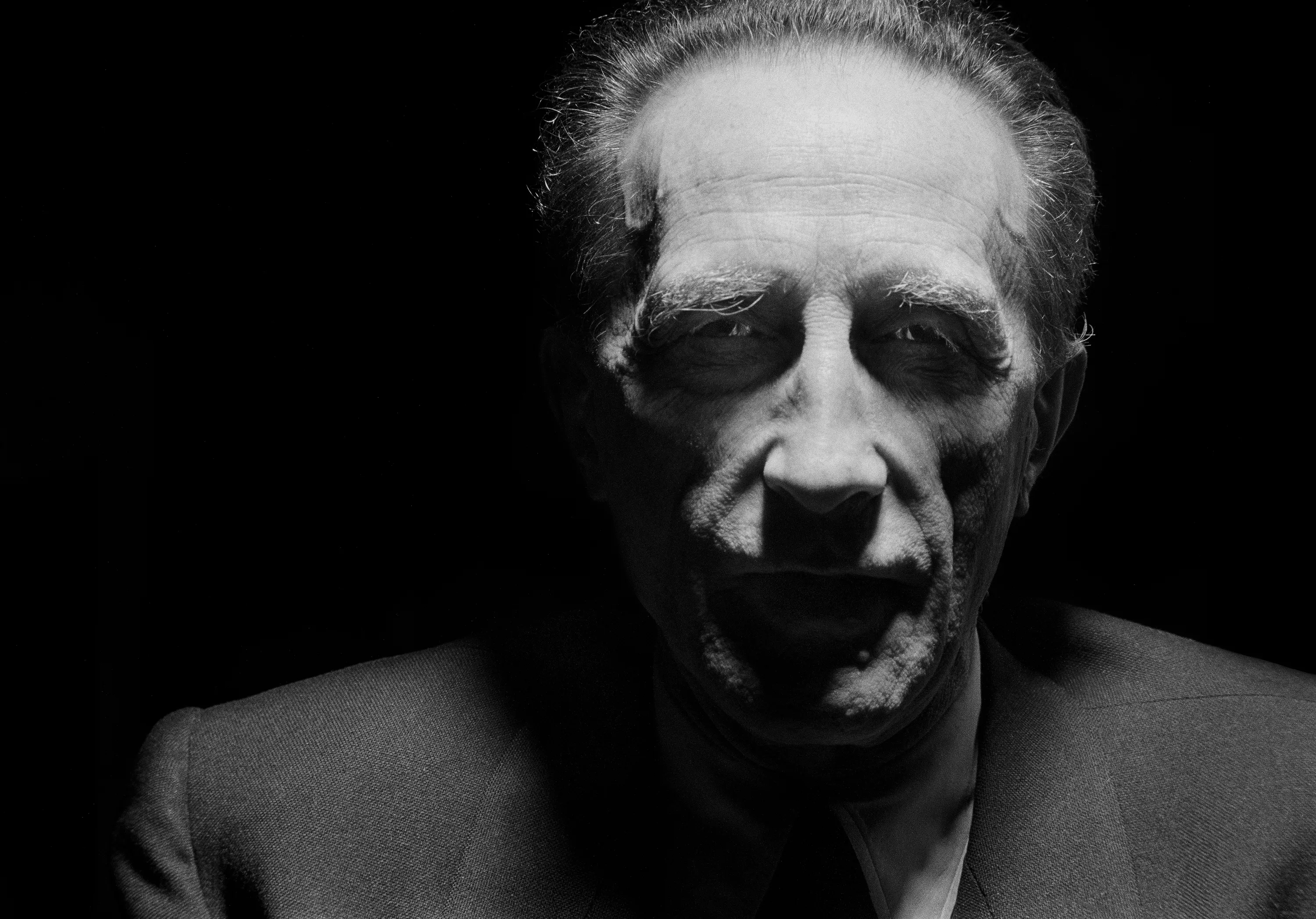 NEW YORK CITY, NEW YORK - 1952: Marcel Duchamp the artist is standing under a street lamp at 4 am in the mornin