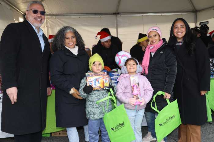 Miguel Centeno, Healthfirst’s Vice President of Community Engagement (far left); Karines Reyes, NYS Assemblymember (second from left); and Amanda Farias, NYC Council Majority Leader (far right) took photos with kids and their familys at Healthfirst & NYPD's annual toy giveaway event in Parkchester on Saturday, Dec. 13th.