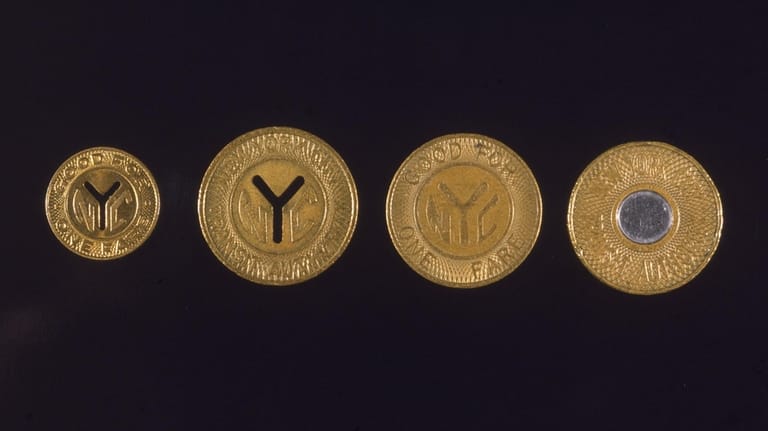 A collection of four New York subway tokens.