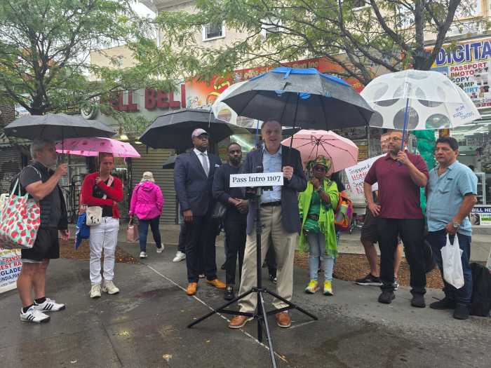 Brendan Levy of the Queens Chamber of Commerce speaks in favor of Intro 1107 at Jackson Heights' Diversity Plaza. The legislation would expand flexibility for short-term rentals, such as Airbnb. Photo: Shane O'Brien.