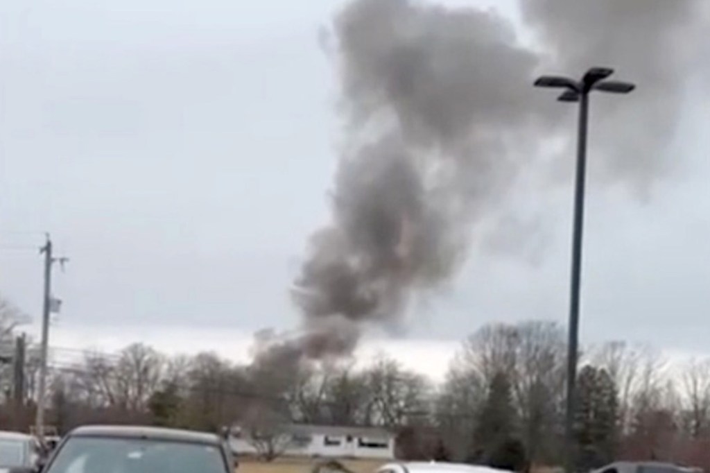 Dark smoke rising from a helicopter collision site in Hammonton, New Jersey.
