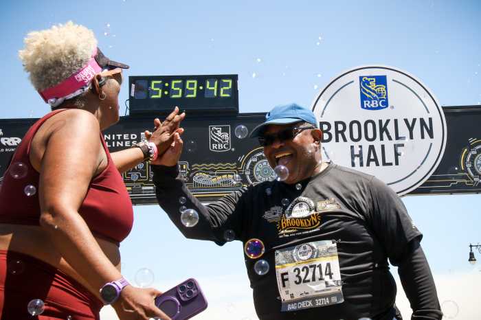 runners high five at brooklyn half marathon