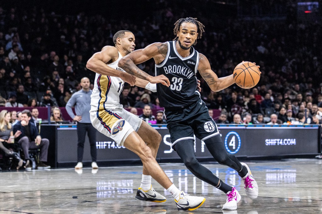 Nic Claxton #33 of the Brooklyn Nets drives pass Bryce McGowens #11 of the New Orleans Pelicans during the second half at Barclays Center, Saturday, Dec. 6, 2025, in Brooklyn, NY. 
