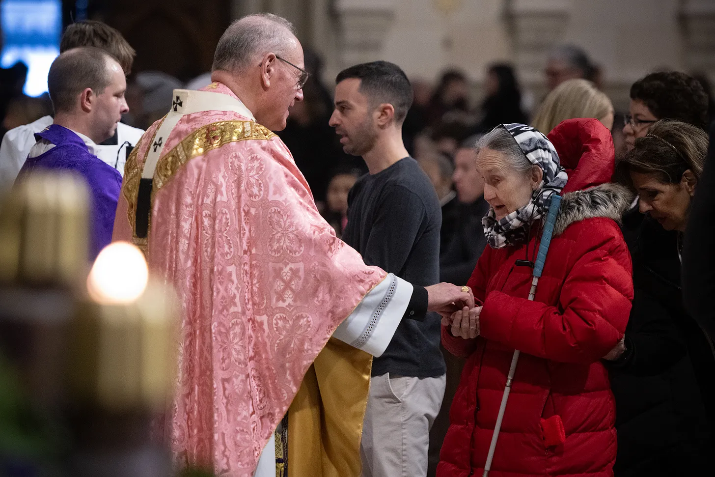 A blind woman takes communion during Mass at St. Patrick's Cathedral in New York City.
