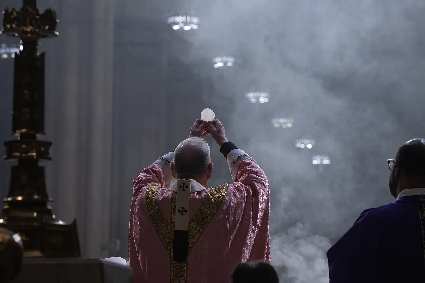 Cardinal Timothy Dolan raises the host during comsecration on Gaudete Sunday.