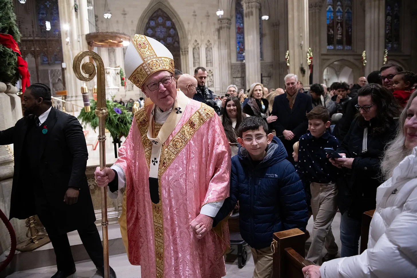 Cardinal Timothy Dolan walks with parishioners after the Mass on Gaudate Sunday.