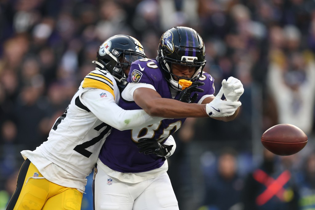 Joey Porter Jr. of the Pittsburgh Steelers breaks up a pass intended for Isaiah Likely of the Baltimore Ravens.