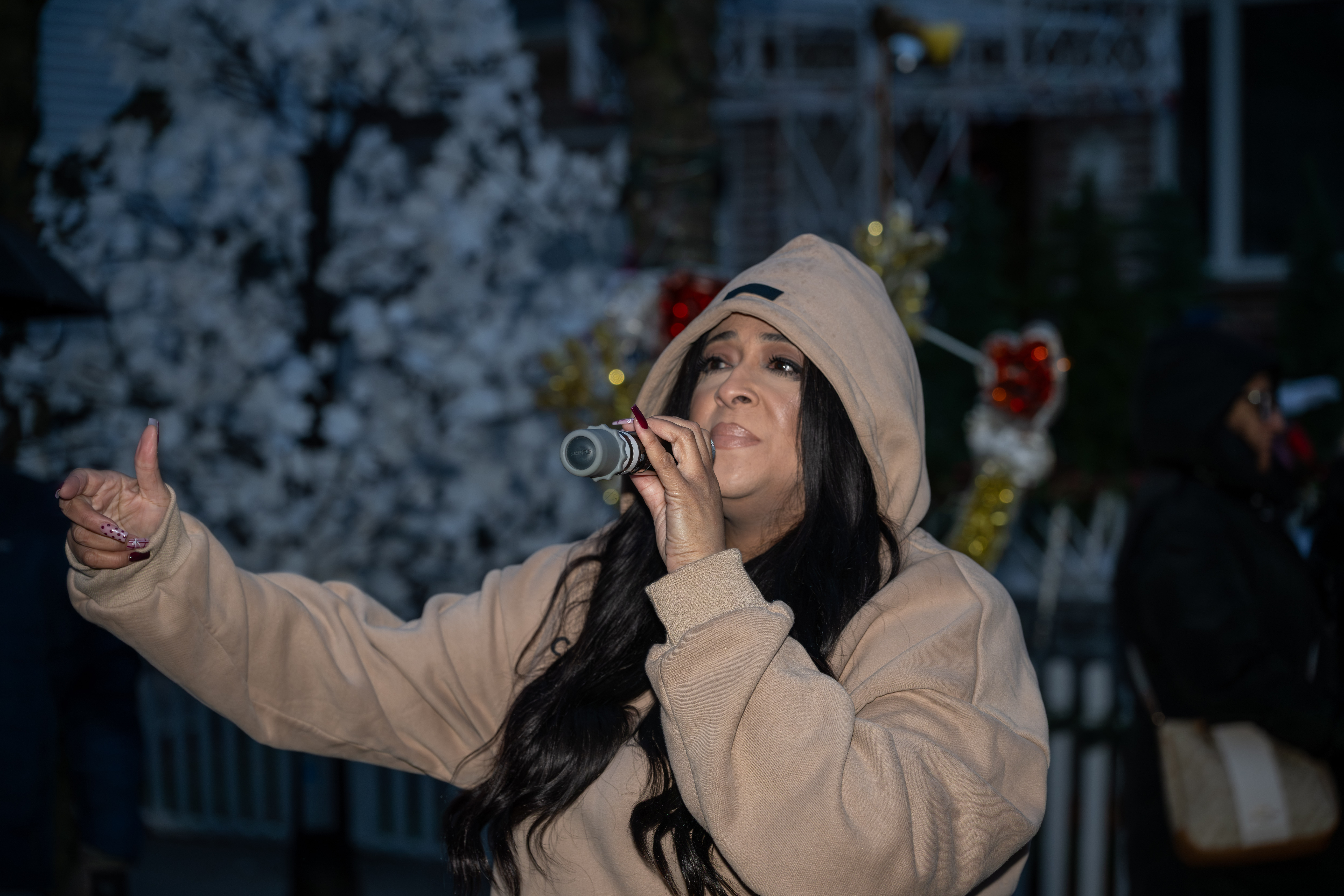 Dance-pop singer-songwriter Reina helps kick off Staten Island’s famous “Lights For Life” Christmas display at the home of Joseph and Marisa DiMartino on Sunday, November 30, 2025, in Charleston. (Owen Reiter for the Advance/SILive.com)