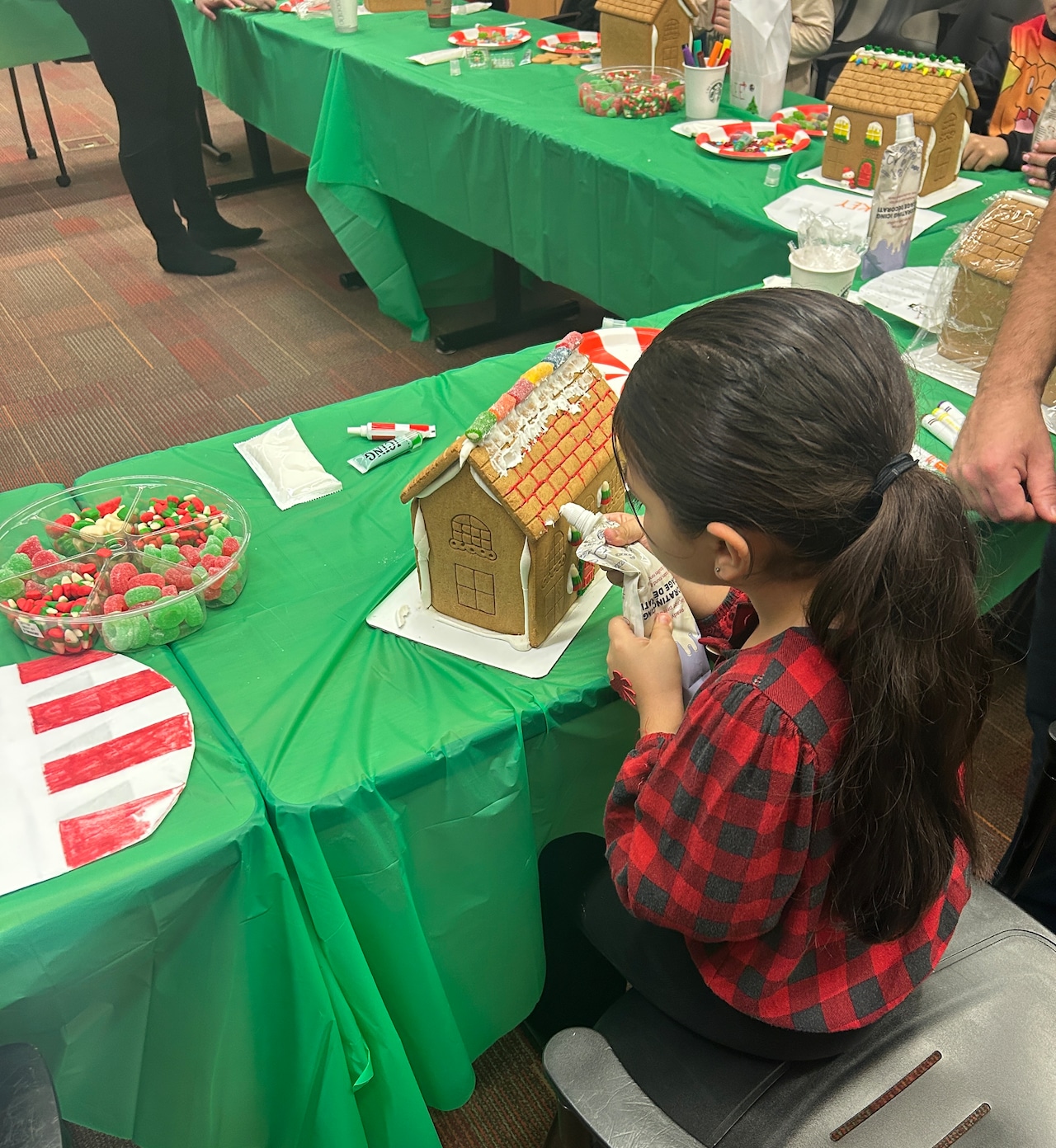 Decorating the gingerbread houses at the "Home for Holidays" workshop