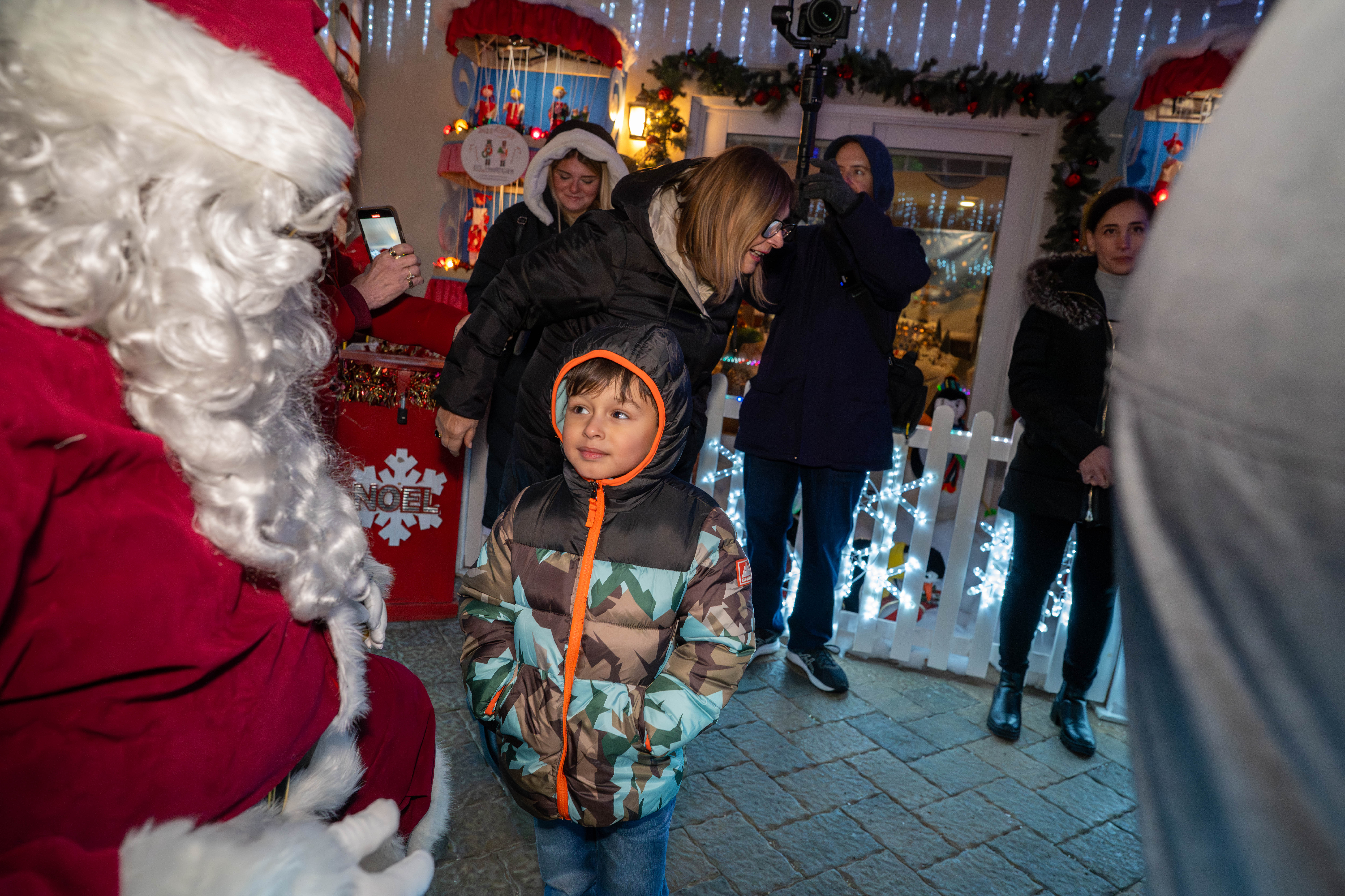 Matthew Reyes, 4, grandson of Taisha Figueroa, a Northwell Staten Island University Hospital employee who is being honored with a Day of Surprises, meets Santa Claus at the DeMartino Christmas House in Charleston on Tuesday, December 16, 2025. (Owen Reiter for the Advance/SILive.com)