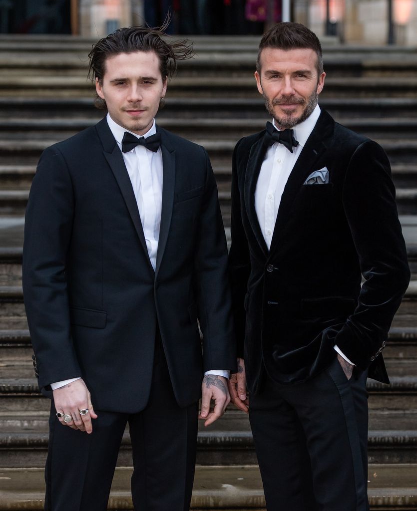 Brooklyn Beckham and David Beckham in black tuxedos