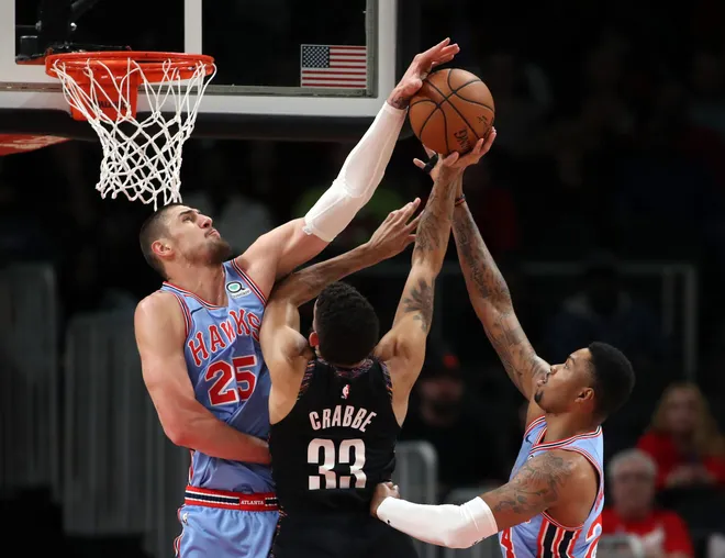Mar 9, 2019; Atlanta, GA, USA; Brooklyn Nets guard Allen Crabbe (33) attempts a shot against Atlanta Hawks center Alex Len (25) and guard Kent Bazemore (24) in the first quarter at State Farm Arena. Mandatory Credit: Jason Getz-USA TODAY Sports