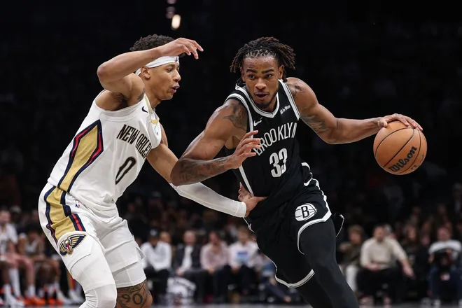 Dec 6, 2025; Brooklyn, New York, USA; Brooklyn Nets center Nic Claxton (33) dribbles asNew Orleans Pelicans as New Orleans Pelicans guard Jeremiah Fears (0) defends during the second half at Barclays Center.