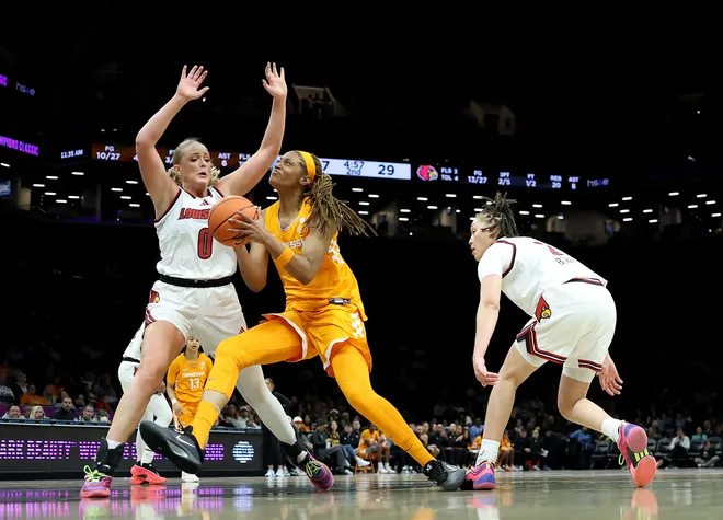 Janiah Barker #0 of the Tennessee Lady Volunteers heads for the net as Laura Ziegler #0 of the Louisville Cardinals defends during the 2025 Women's Champions Classic at Barclays Center on December 20, 2025 in the Brooklyn borough of New York City.