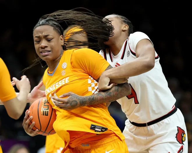 Zee Spearman #11 of the Tennessee Lady Volunteers and Mackenly Randolph #4 of the Louisville Cardinals fight for the jump ball during the 2025 Women's Champions Classic at Barclays Center on December 20, 2025 in the Brooklyn borough of New York City.