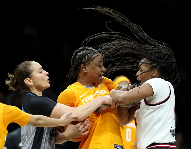 Zee Spearman #11 of the Tennessee Lady Volunteers and Mackenly Randolph #4 of the Louisville Cardinals fight for the jump ball during the 2025 Women's Champions Classic at Barclays Center on December 20, 2025 in the Brooklyn borough of New York City.