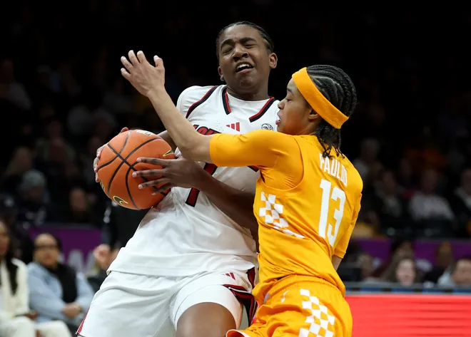 Reyna Scott #1 of the Louisville Cardinals heads for the net as Mia Pauldo #13 of the Tennessee Lady Volunteers defends during the 2025 Women's Champions Classic at Barclays Center on December 20, 2025 in the Brooklyn borough of New York City.