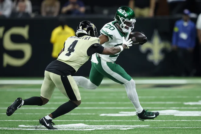 NEW ORLEANS, LOUISIANA - DECEMBER 21: Kool-Aid McKinstry #4 of the New Orleans Saints attempts to tackle Breece Hall #20 of the New York Jets during the second quarter at Caesars Superdome on December 21, 2025 in New Orleans, Louisiana. (Photo by Chris Graythen/Getty Images)