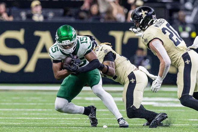 Dec 21, 2025; New Orleans, Louisiana, USA; New Orleans Saints safety Justin Reid (21) tackles New York Jets wide receiver Adonai Mitchell (15) during the second half at Caesars Superdome. Mandatory Credit: Stephen Lew-Imagn Images