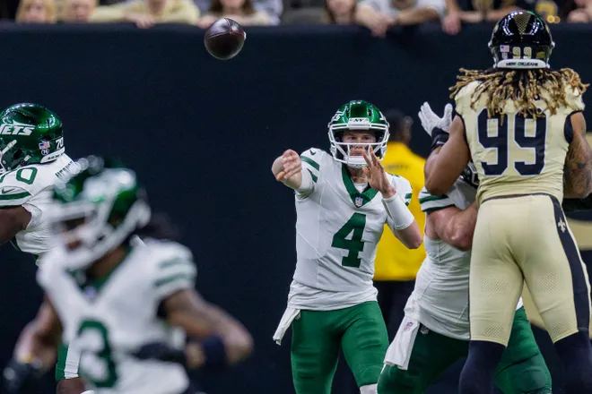 Dec 21, 2025; New Orleans, Louisiana, USA; New York Jets quarterback Brady Cook (4) passes against New Orleans Saints defensive end Chase Young (99) during the first half at Caesars Superdome. Mandatory Credit: Stephen Lew-Imagn Images