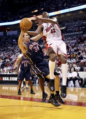 MIAMI - MAY 10: Scott Padgett #34 of the New Jersey Nets fouls James Posey #42 of the Miami Heat in game two of the Eastern Conference Semifinals during the 2006 NBA Playoffs at American Airlines Arena on May 10, 2006 in Miami, Florida. The Heat defeated the Nets 111-89 to tie the series 1-1. NOTE TO USER: User expressly acknowledges and agrees that, by downloading and/or using this Photograph, user is consenting to the terms and conditions of the Getty Images License Agreement. (Photo by Doug Benc/Getty Images)