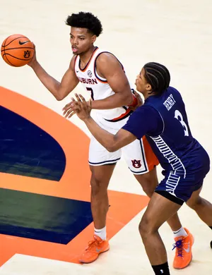 Auburn Tigers forward Keyshawn Hall (7) is defended by Queens University's Isaiah Henry (3) during their game at Neville Arena on the Auburn University campus in Auburn, Ala., on Monday evening December 29, 2025.