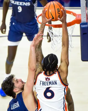 Auburn Tigers guard Elyjah Freeman (6) dunks again st Queens University's Gus Larson (7) during their game at Neville Arena on the Auburn University campus in Auburn, Ala., on Monday evening December 29, 2025.