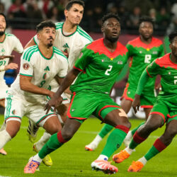 Algeria and Burkina Faso players anticipate a corner kick during the Africa Cup of Nations group E soccer match between Algeria and Burkina Faso in Rabat, Morocco, Sunday, Dec. 28, 2025. (AP Photo/Mosa'ab Elshamy)