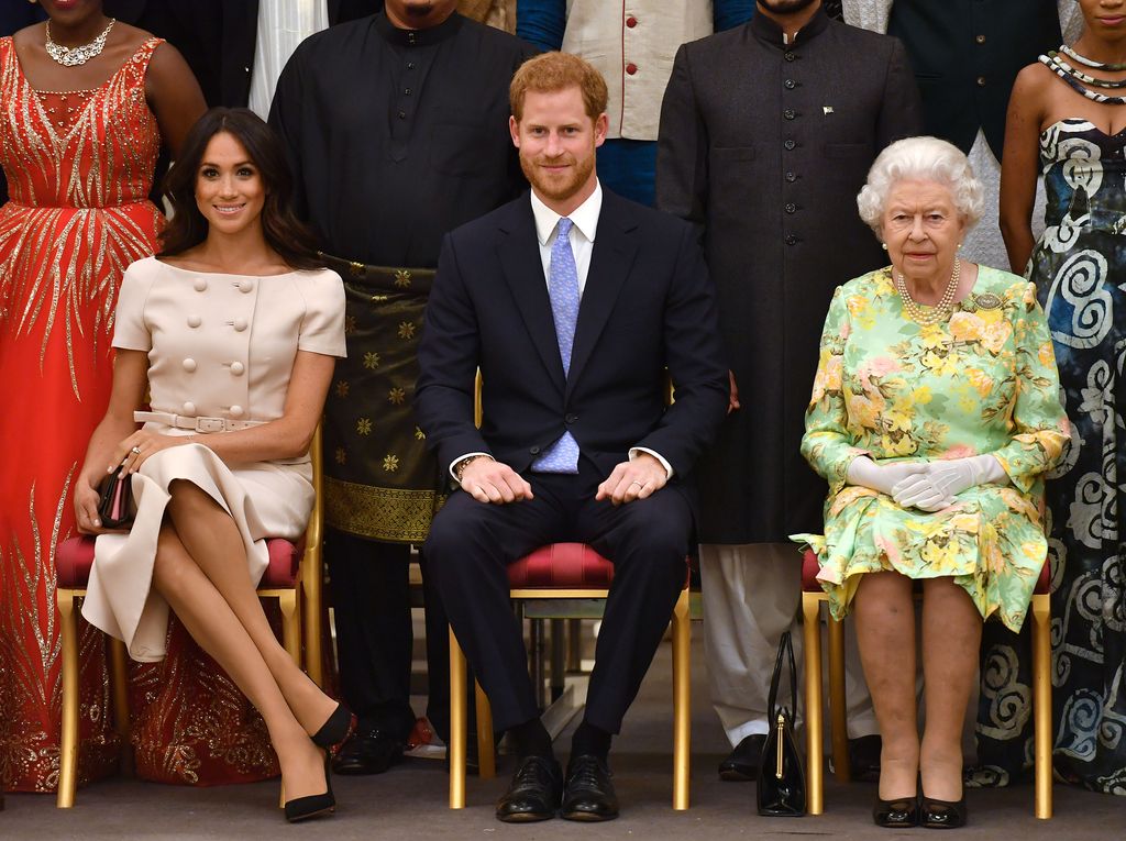 Meghan Markle, Prince Harry and Queen Elizabeth II at the Queen's Young Leaders Awards Ceremony at Buckingham Palace