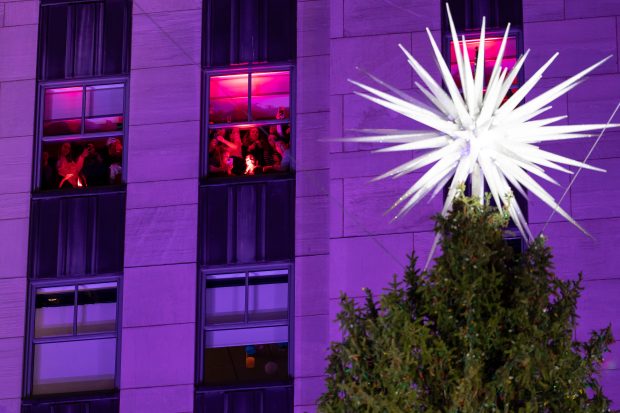 People look out of the window during the 93rd annual Rockefeller Center Christmas tree lighting ceremony, Wednesday, Dec. 3, 2025, in New York. (AP Photo/Yuki Iwamura)