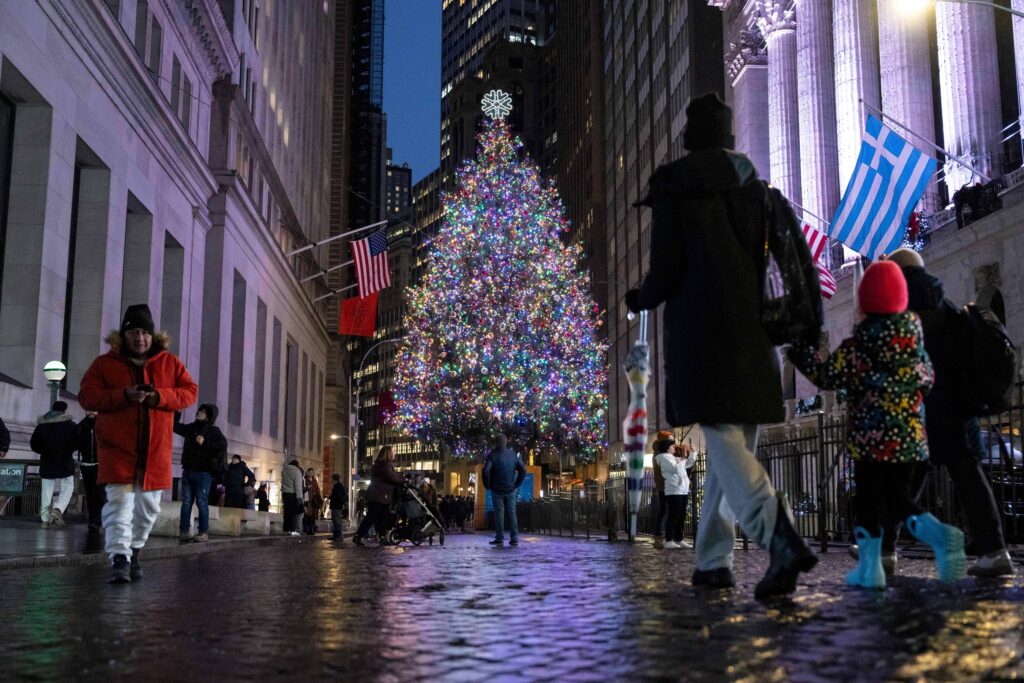 People walk past a Christmas tree outside the New York Stock Exchange, Wednesday, Dec. 10, 2025, in New York. Photo: Yuki Iwamura/AP