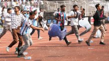 Indian fans vandalize stadium chairs as they run on to the field after failing to get a glimpse of Argentine soccer star Lionel Messi at the Salt Lake Stadium, in Kolkata, India, Saturday, Dec. 13, 2025. (AP Photo/Bikas Das)