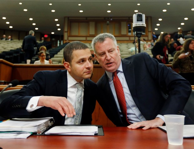 FILE - New York City Mayor Bill de Blasio, right, talks with his legislative affairs director Sherif Soliman before a joint legislative budget hearing on local government on Wednesday, Feb. 25, 2015, in Albany, New York. (AP Photo/Mike Groll)