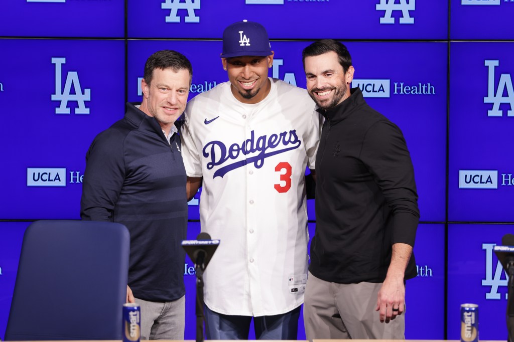 Edwin Díaz, middle, poses for photos next to General Manager Brandon Gomes, right, and President of Baseball Operations Andrew Friedman during his introduction as a new member of the Los Angeles Dodgers baseball team Friday, Dec. 12, 2025, in Los Angeles.