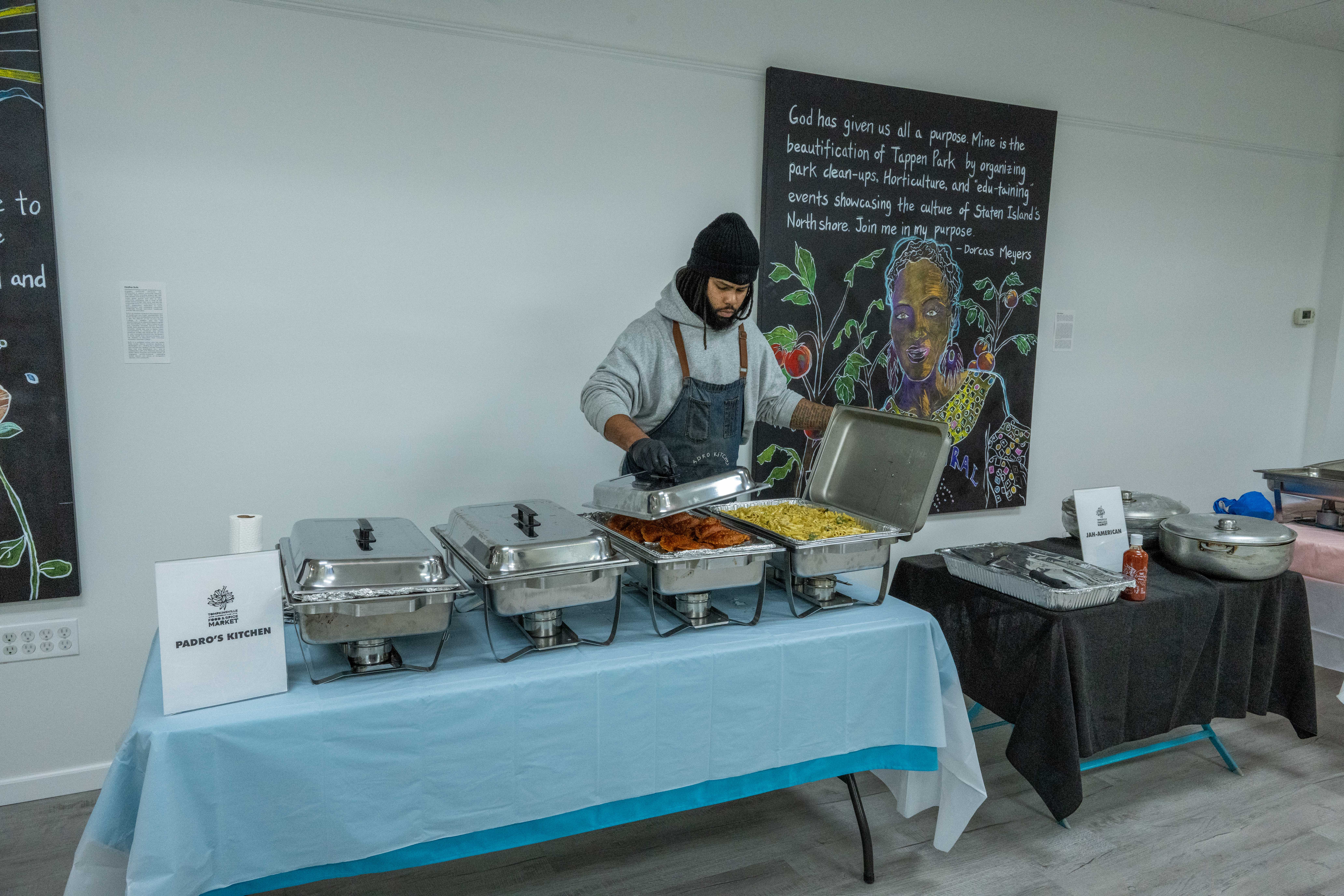 Jonathan Prado, owner/chef of Prado’s Kitchen, gets ready to serve food at the grand opening of the Staten Island Urban Center’s new storefront at 206 Bay Street in Tompkinsville on Saturday, December 6, 2025. (Owen Reiter for the Advance/SILive.com)