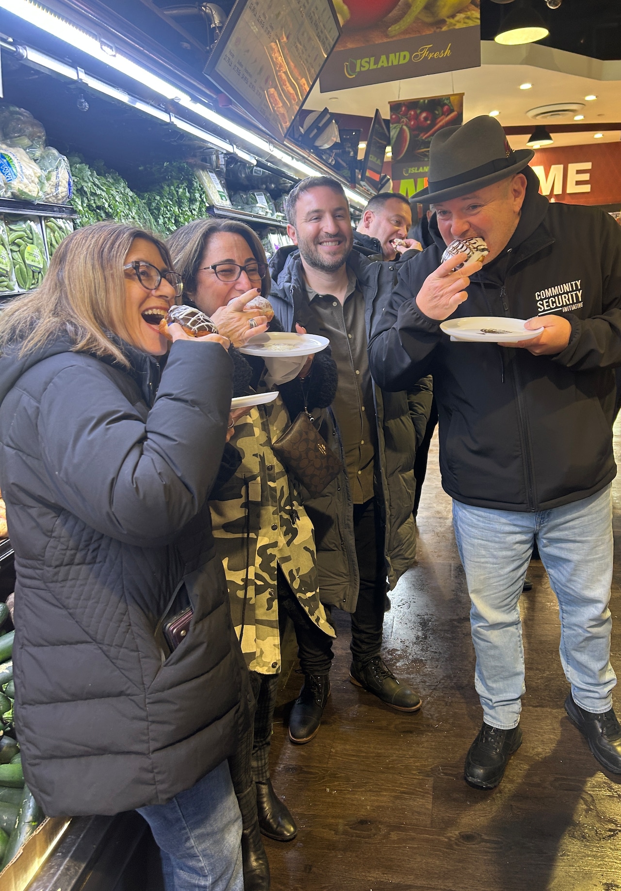 Participants enjoying sufganiyot at Island Kosher