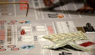 Money lies on the table during a craps game at the public opening of Resorts World Catskills in Monticello, N.Y., Thursday, Feb. 8, 2018. (AP Photo/Seth Wenig)