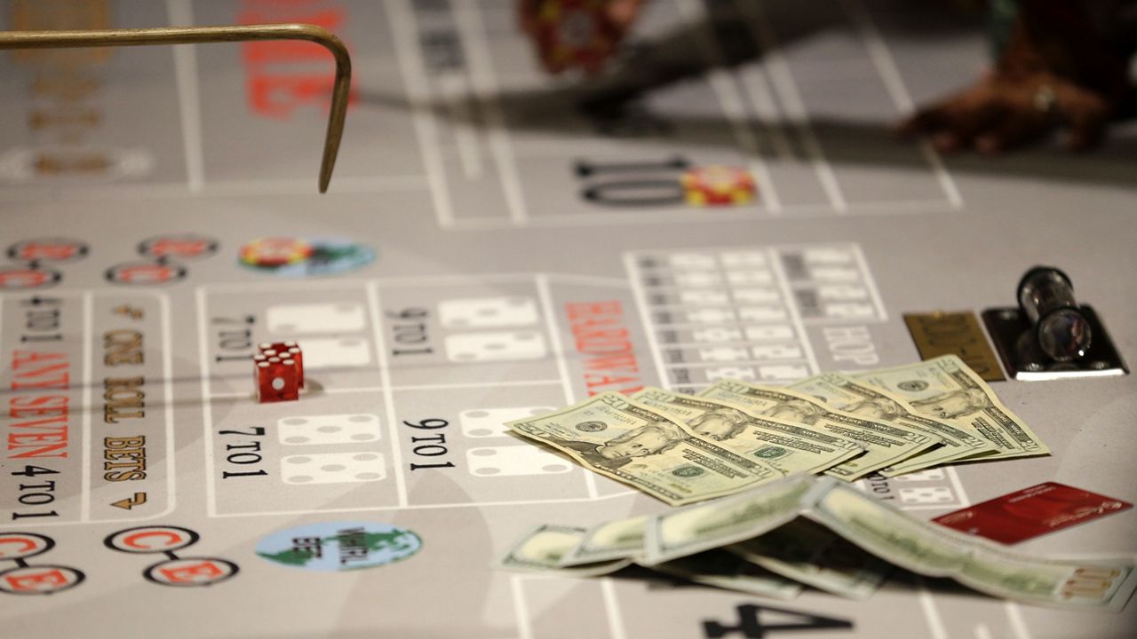 Money lies on the table during a craps game at the public opening of Resorts World Catskills in Monticello, N.Y., Thursday, Feb. 8, 2018. (AP Photo/Seth Wenig)