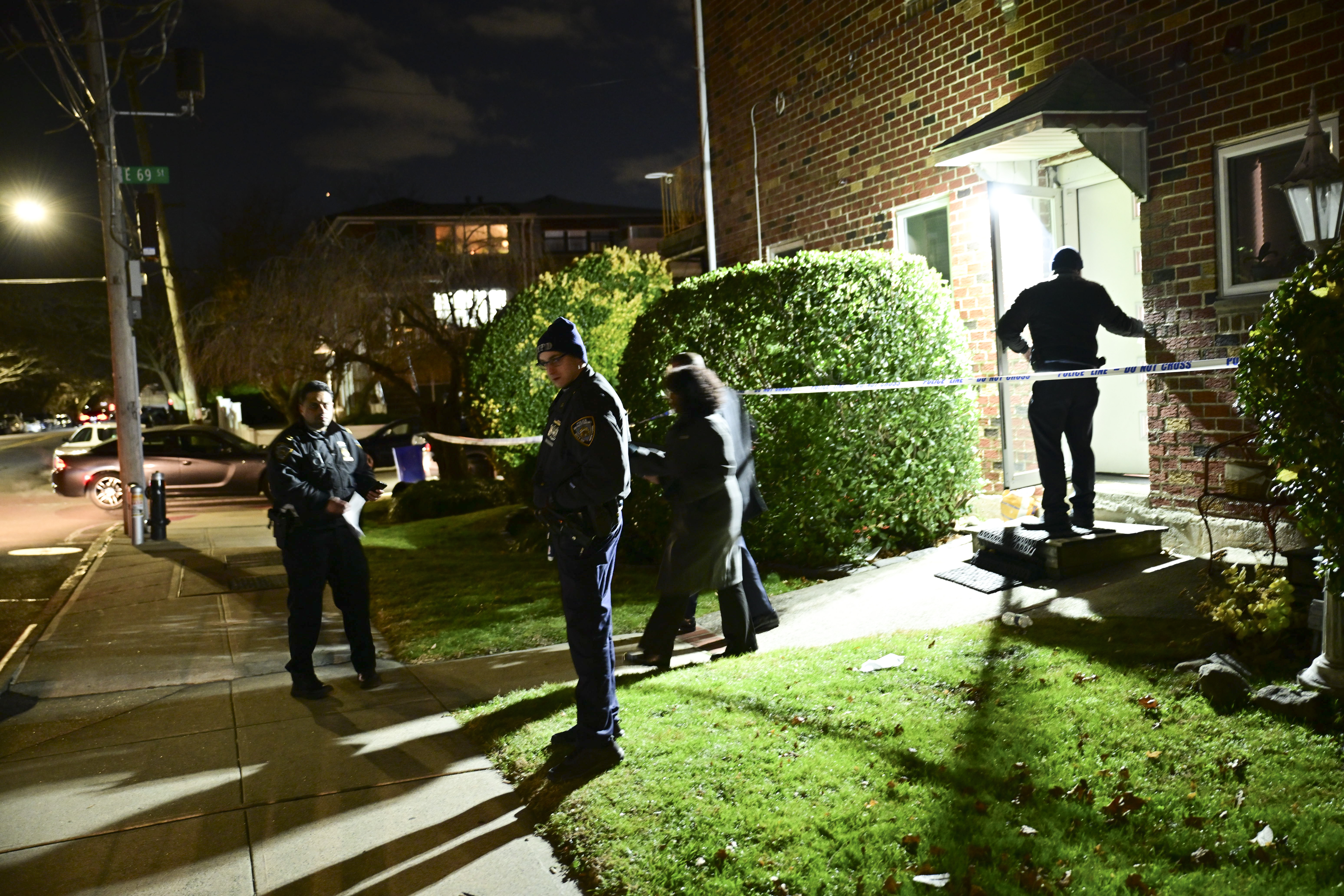 Detectives investigate the scene of a double stabbing that left one man dead and a woman in critical condition.