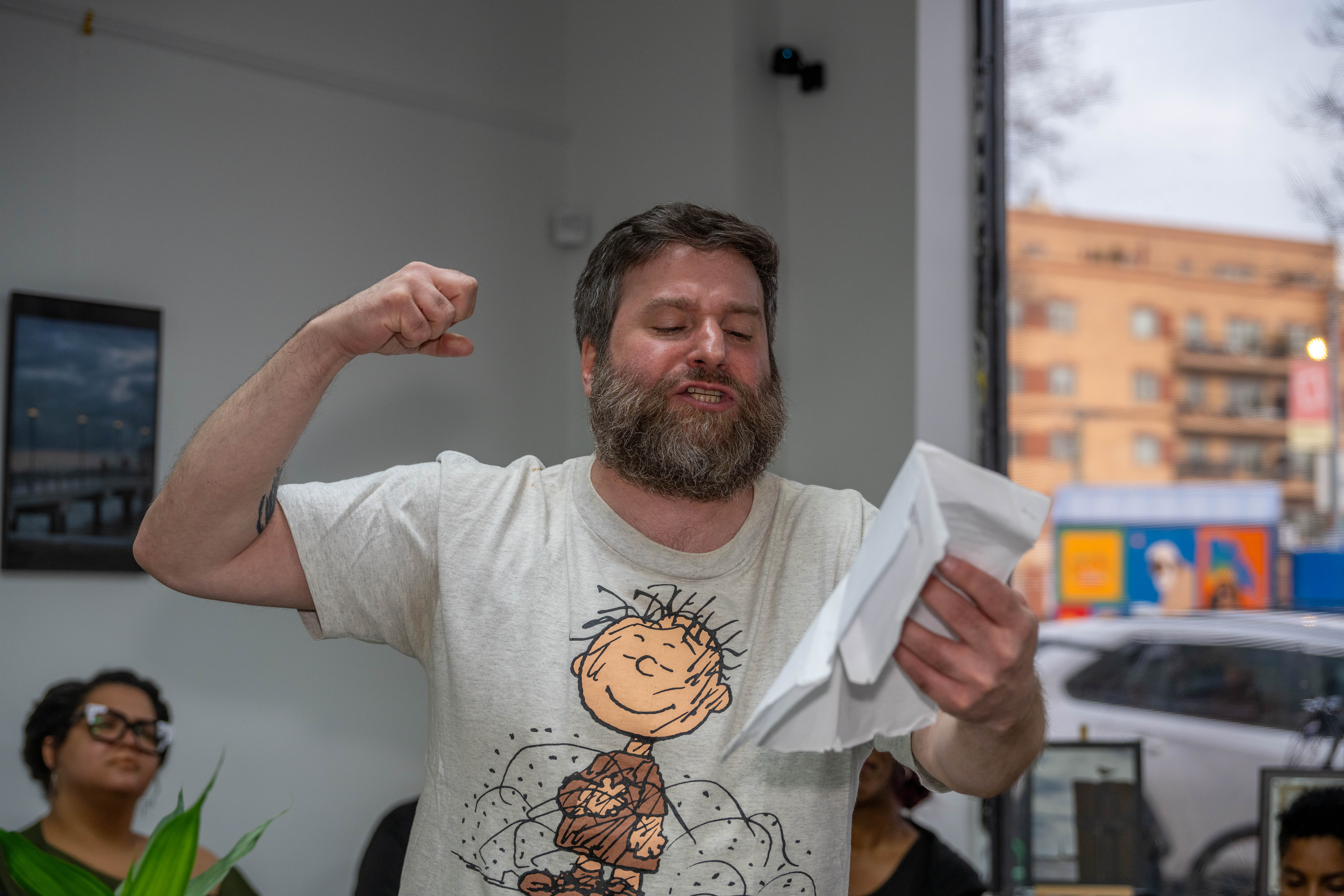Thomas Fucaloro recites a poem at the grand opening of the Staten Island Urban Center’s new storefront at 206 Bay Street in Tompkinsville on Saturday, December 6, 2025. (Owen Reiter for the Advance/SILive.com)
