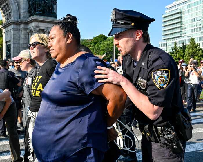 officer arresting marcela mitaynes after rally