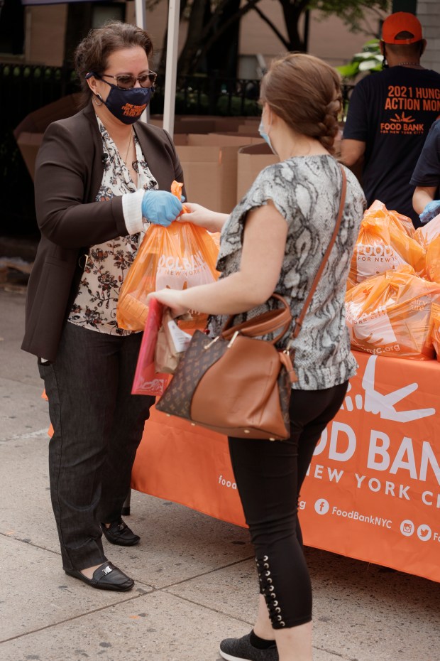 Chief Executive Officer of Elmhurst Hospital Helen Arteaga helps hand out food and other items to Queens residents as part of Food Bank for New York City's 5 Borough Pop Up Tour in partnership with NYC Health + Hospitals and Grubhub at Elmhurst Hospital on Sept. 16, 2021, in Queens, New York. (Photo by Michael Loccisano/Getty Images for Food Bank For New York City)