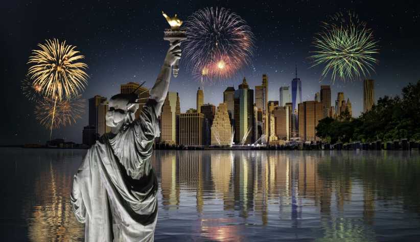 Depiction of the Statue of Liberty standing in front of the Manhattan skyline and fireworks to celebrate America's 250th birthday