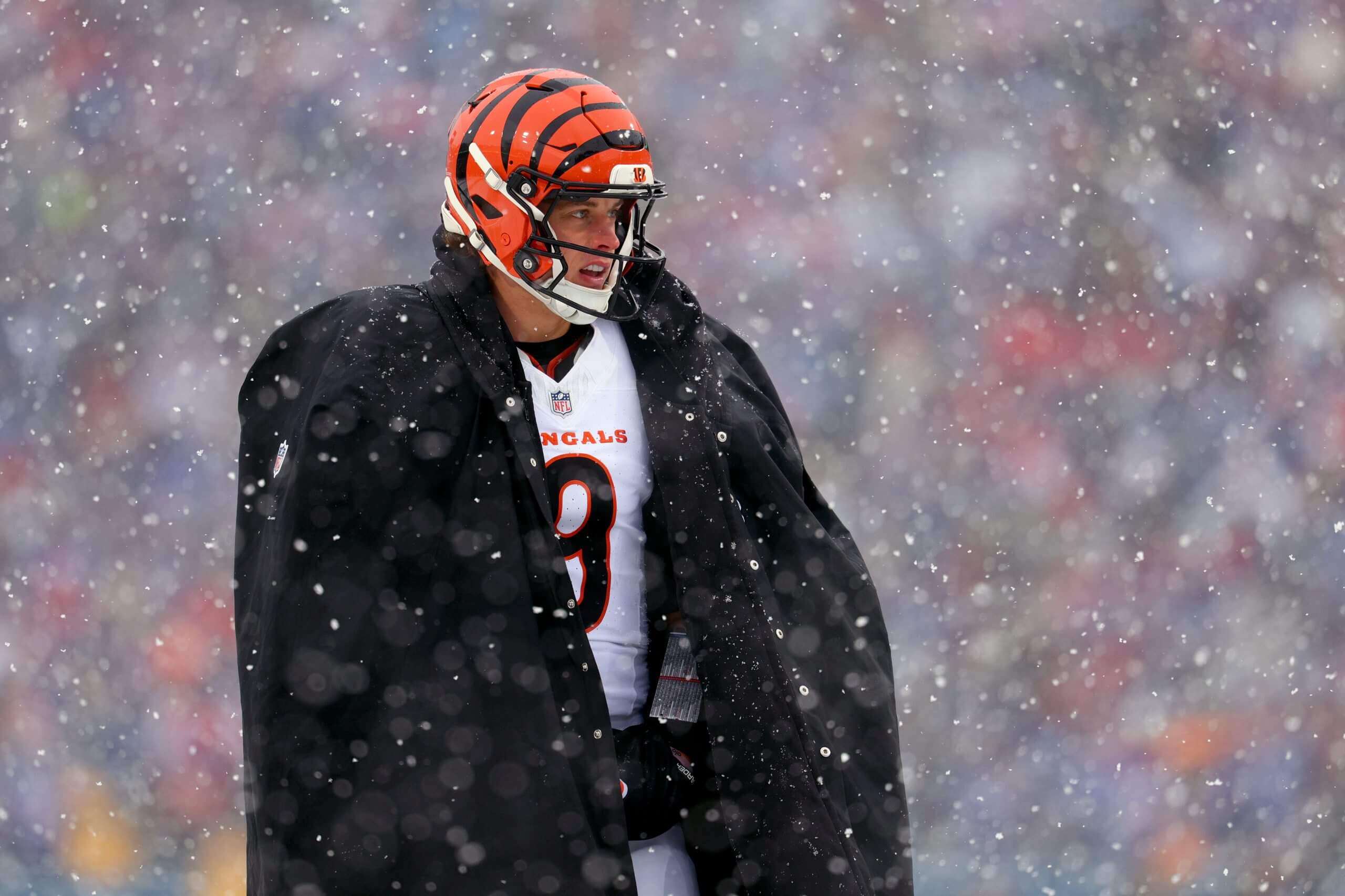 Bengals quarterback Joe Burrow wears a large parka in the snow during a game against the Buffalo Bills.