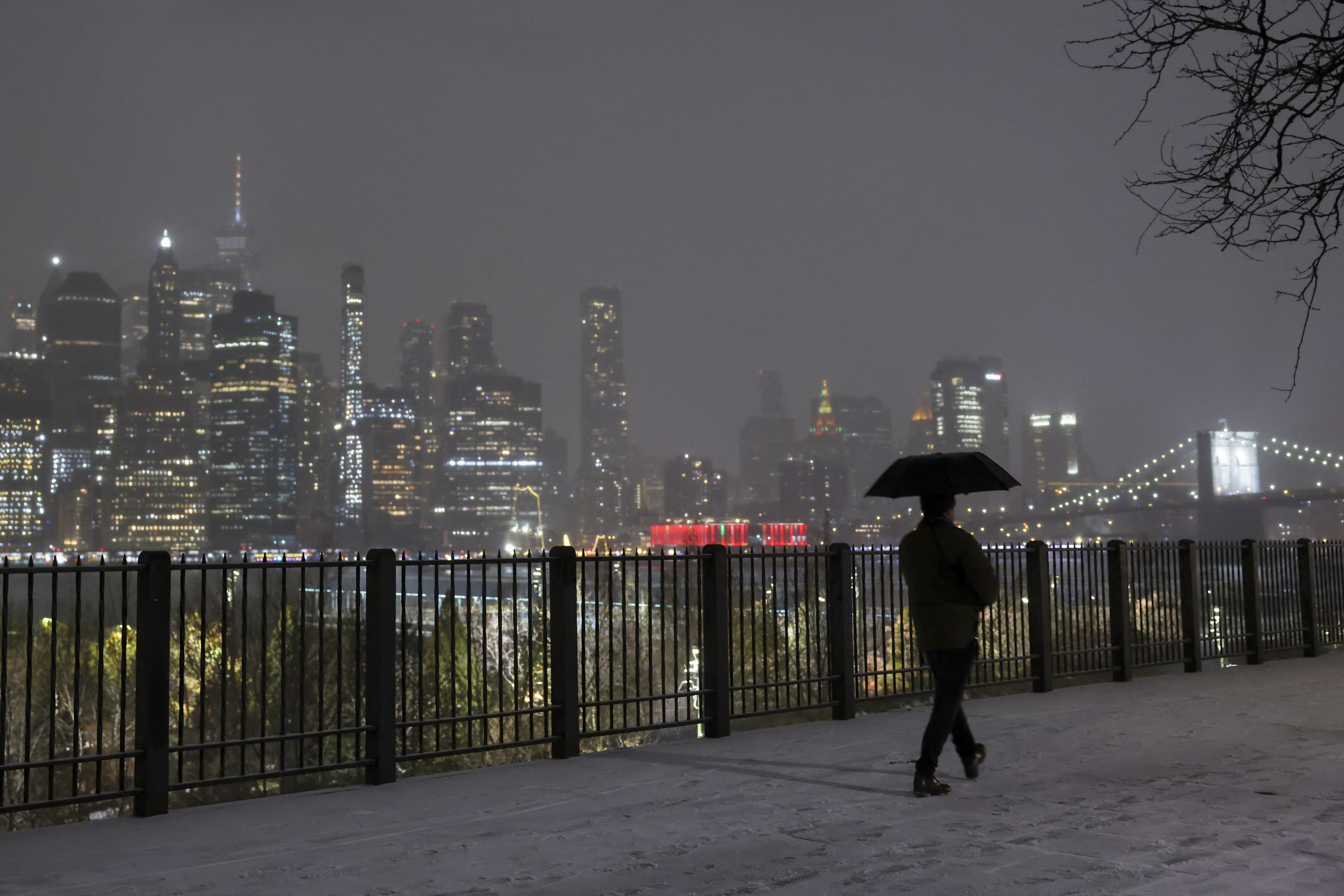 A person walks through snow on December 26, 2025 in...