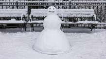 A snowman stands near a park bench in New York City on December 27, 2025. New York City receieved around 4 inches (10 centimeters) of snow overnight. Airlines canceled 1,500 US flights during the peak holiday travel period Friday, with severe winter storm warnings and heavy snow forecast across parts of the Midwest and northeast. (Photo by ANGELA WEISS / AFP via Getty Images)
