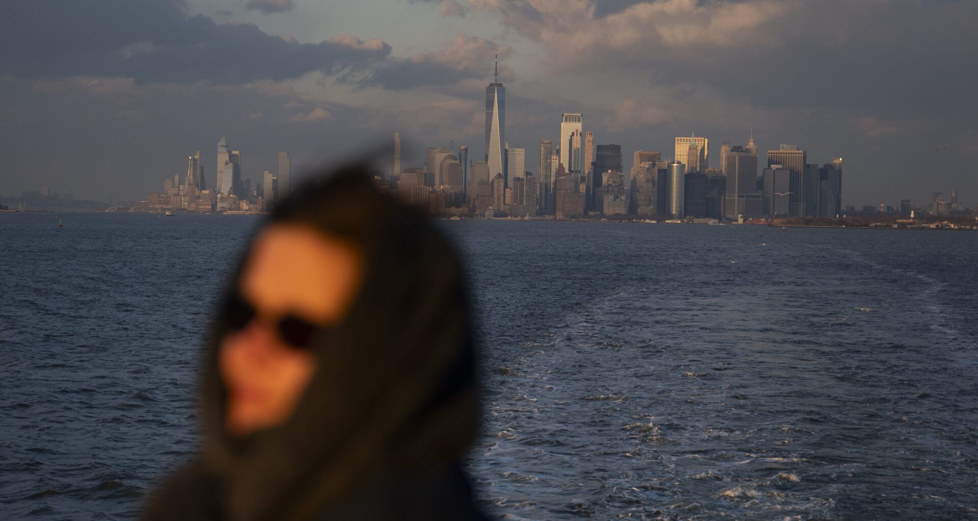 A woman rides the Staten Island ferry away from Manhattan earlier this year