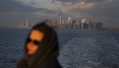 A woman rides the Staten Island ferry away from Manhattan earlier this year
