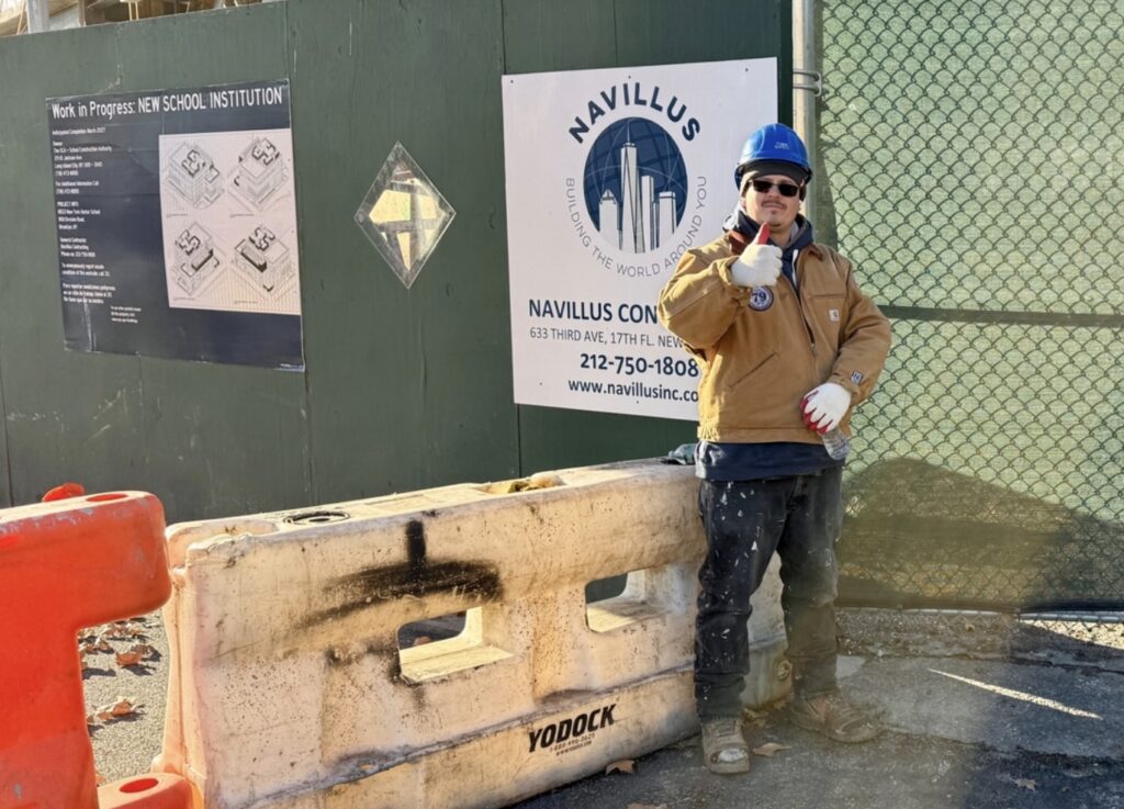Mike, a construction worker, stands in front of the new Harbor School building construction. (Credit: Baron Carr)